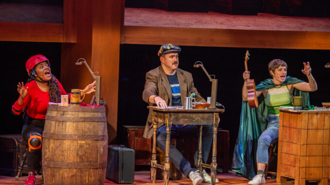 Three cast members pose in front of mismatched tables